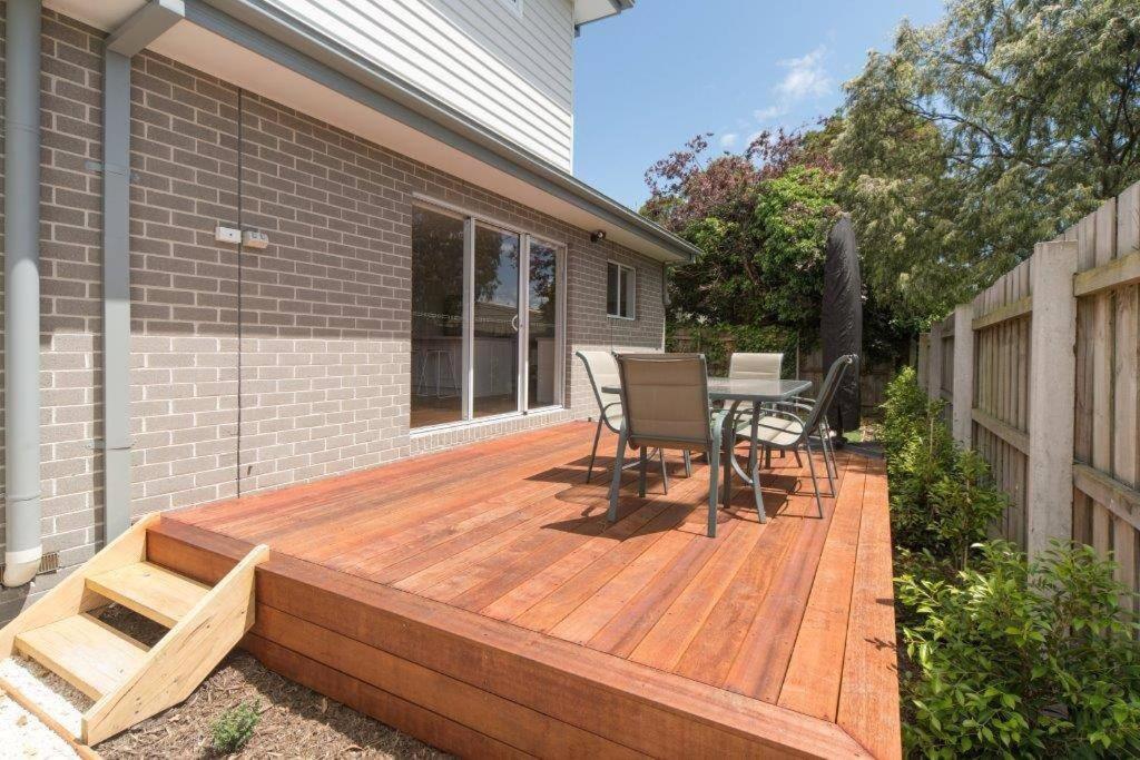 a wooden deck with a table and chairs on a house at Rosebud Lovely House 2 - Mornington Peninsula 4 BR 3 Bath 2 story holiday house - BBQ - Beach - Hot spring in Rosebud