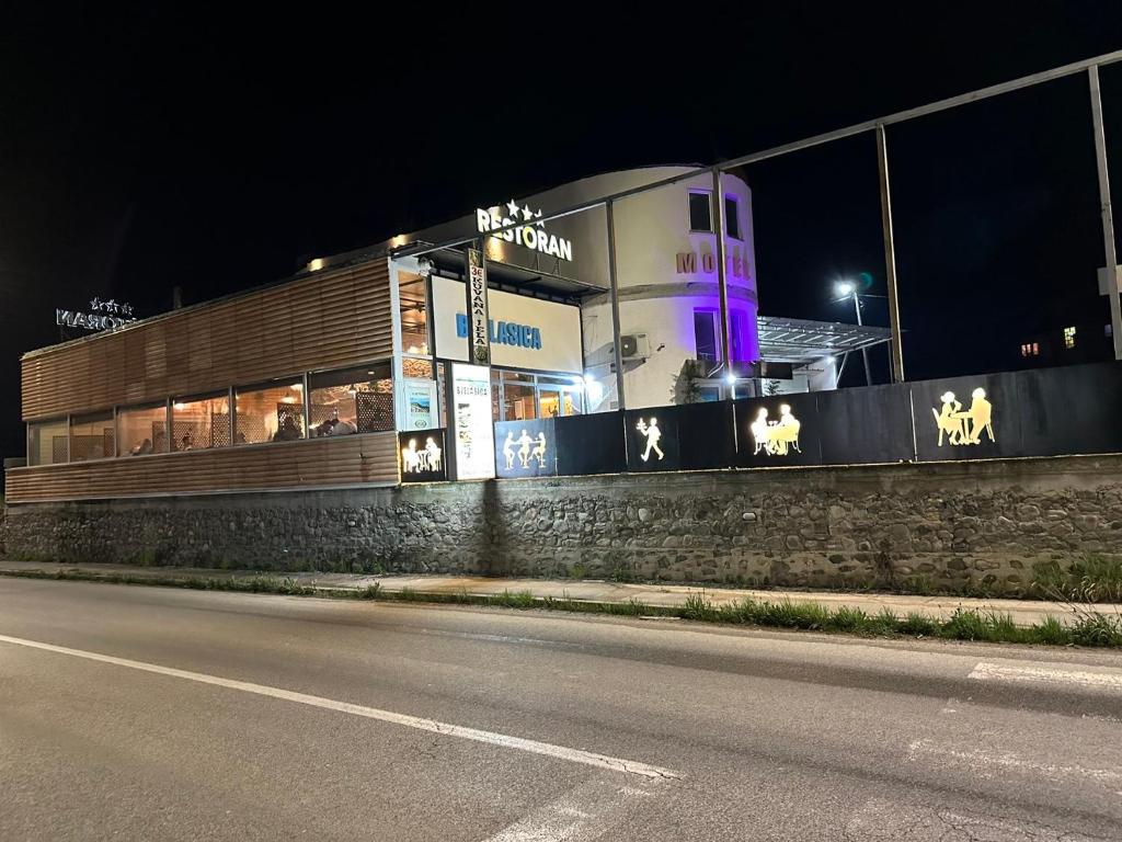 a building on the side of a street at night at Apartmani BJELASICA in Bijelo Polje