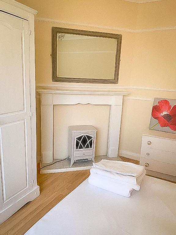 a living room with a fireplace and a mirror at Spacious 7 bed, Contractor Accommodation Stockton on tees in Stockton-on-Tees