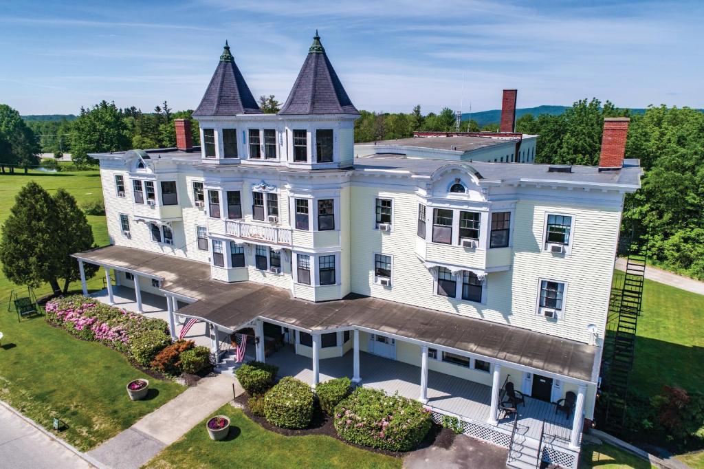 an aerial view of a large white house with a turret at The Presidential Inn at Poland Spring Resort in Poland