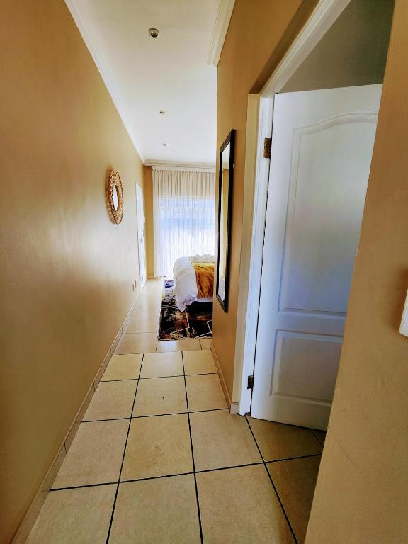 a hallway with a room with a bed and a door at 136 on 4th in Johannesburg
