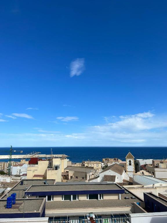 a view of a city with the ocean in the background at Ático duplex con Vista Mar y Terraza Privada a 200m de la playa hasta 6 personas in Garrucha