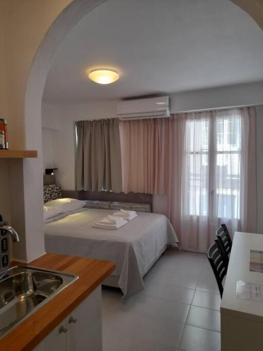 a bedroom with a bed and a sink in a room at CorfuCenterStudios2 in Corfu