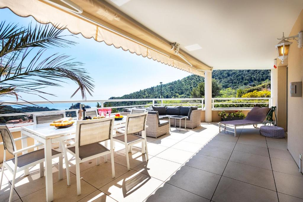un patio avec une table et des chaises et une vue sur l'océan dans l'établissement EZE VISTA AP4328 By Riviera Holiday Homes, à Èze
