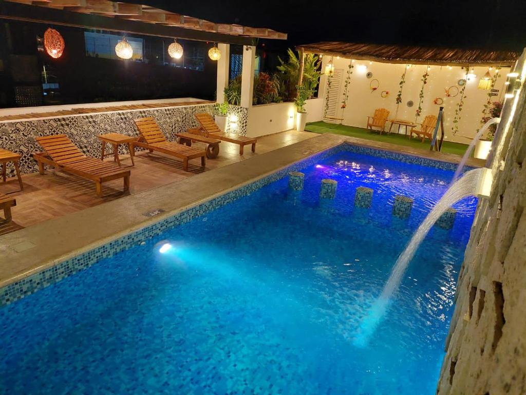 a swimming pool with a water feature in a house at Hotel Ko'ox Wenne in Tulum