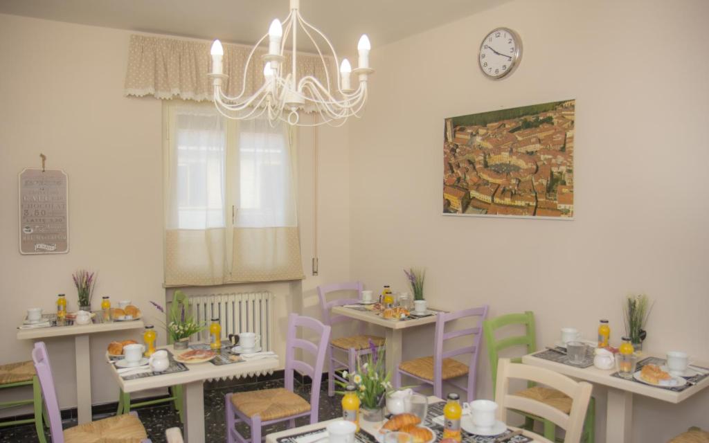 un comedor con mesas y sillas y un reloj en la pared en Il Linchetto, en Lucca
