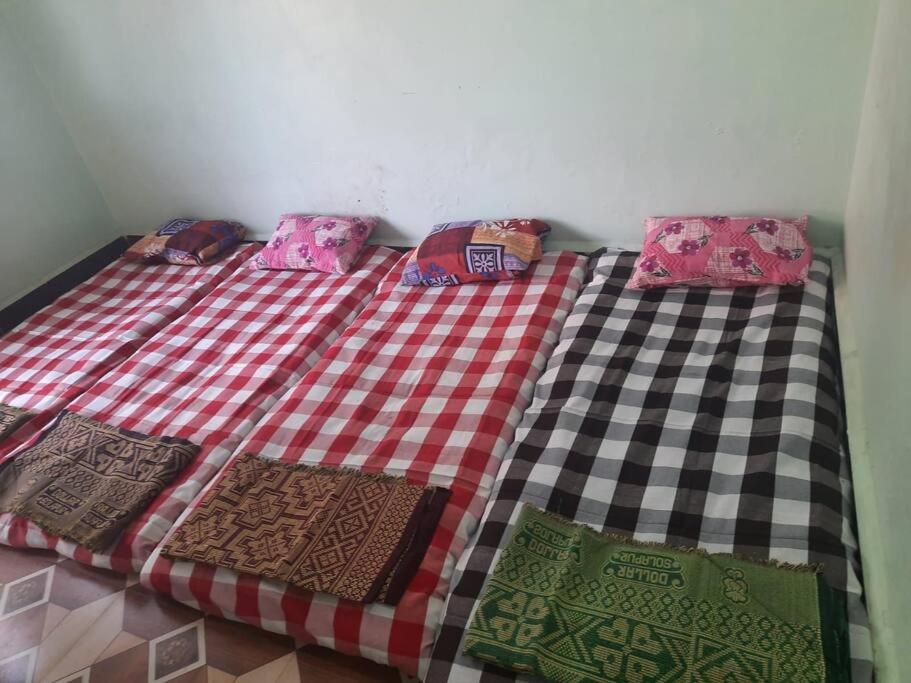 a bed with four pillows on top of it at Bhaktikunj Detached 2 room House in Akalkot
