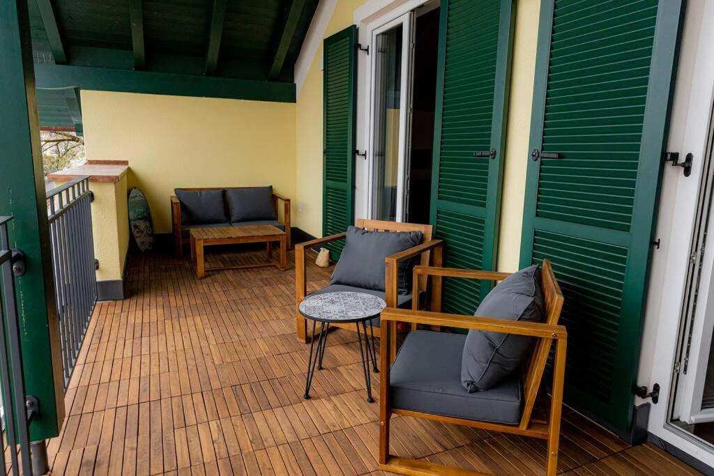 a porch with two chairs on a house at Servus Apartments Neuhaus am Inn in Neuhaus am Inn