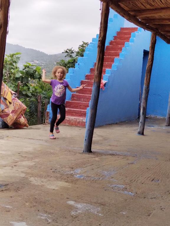 a little girl running up a set of stairs at يسوال 