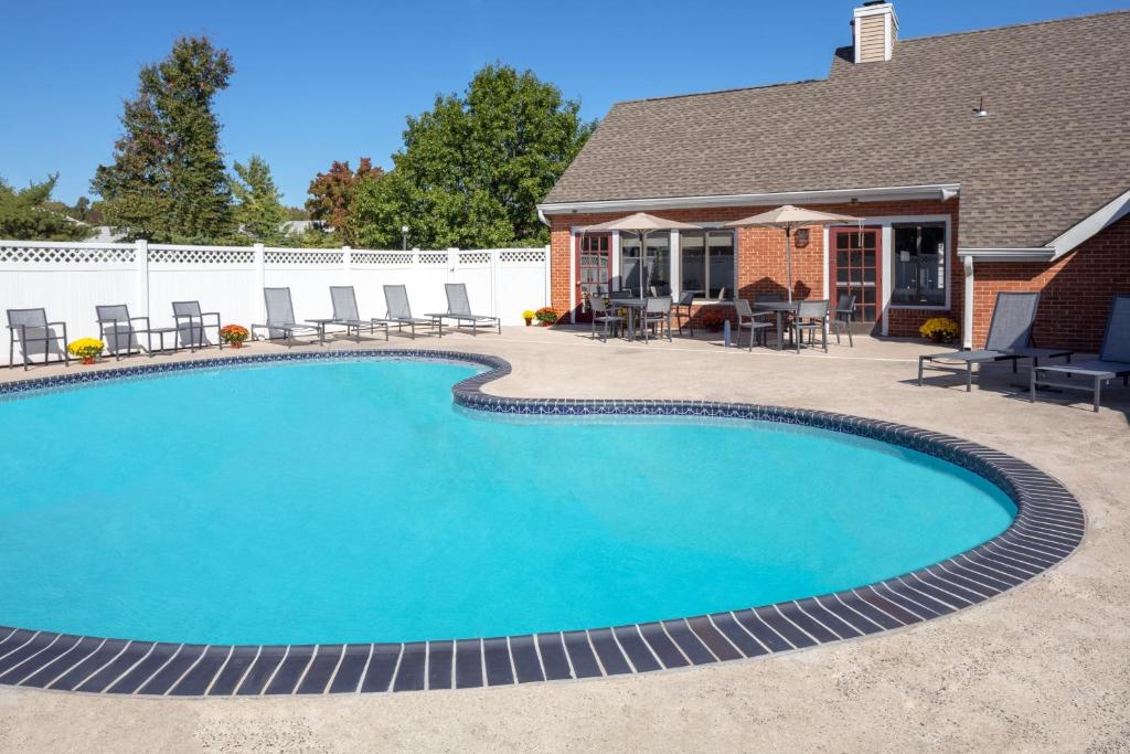 a swimming pool in front of a house at Residence Inn Cherry Hill Philadelphia in Cherry Hill