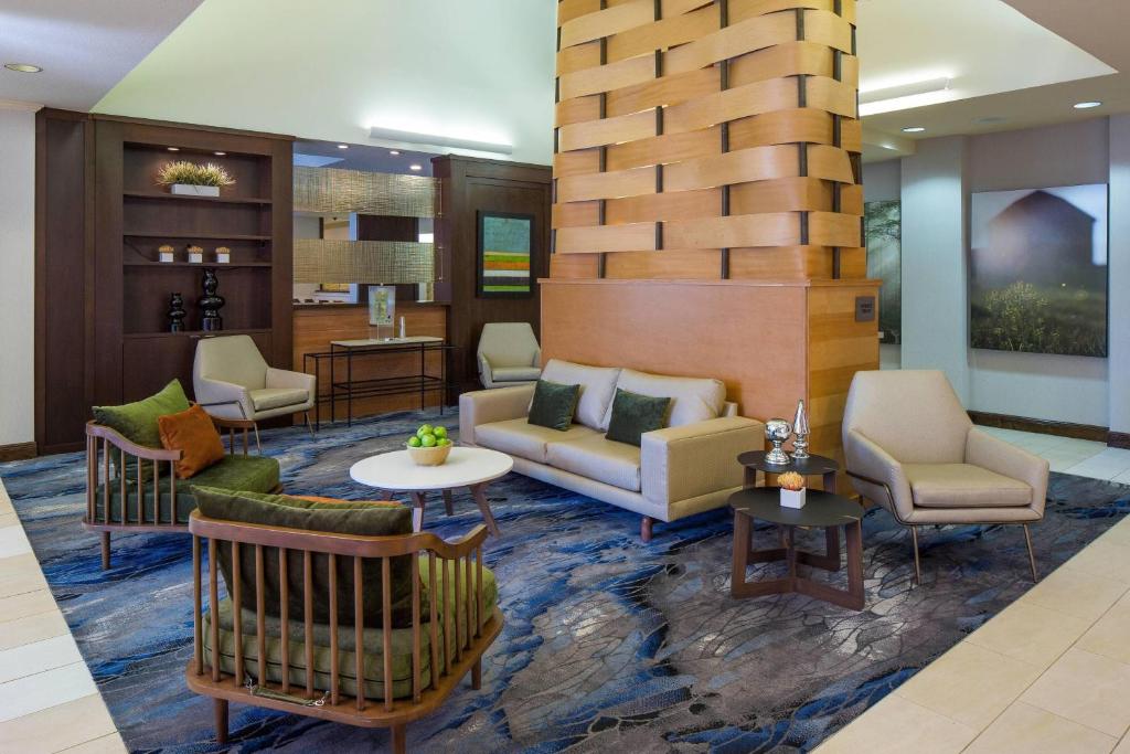 a lobby of a hotel with couches and chairs at Fairfield Inn & Suites by Marriott Orlando Lake Buena Vista in Orlando