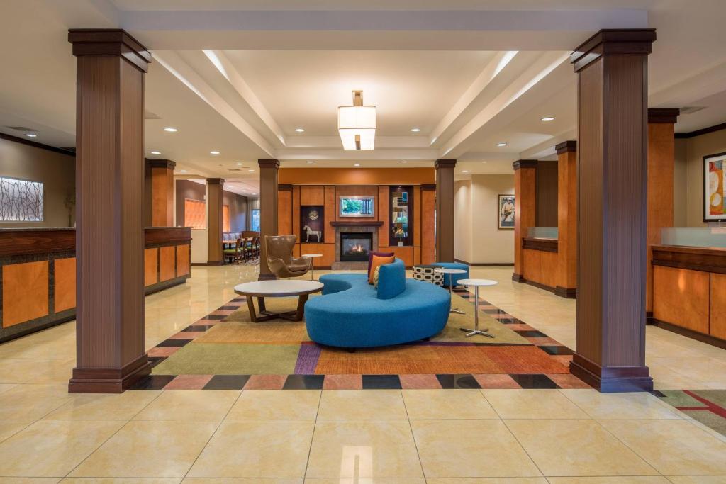 a lobby with a blue couch in the middle of a room at Fairfield Inn & Suites by Marriott Portland North in Portland