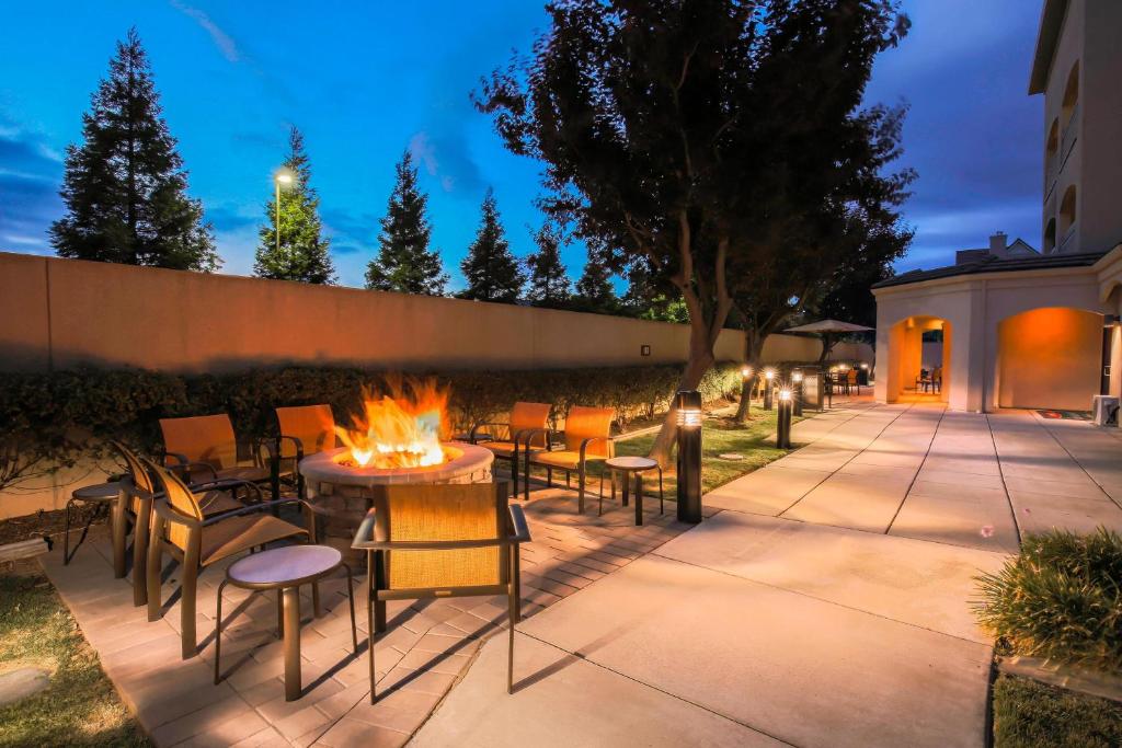 a patio with a table and chairs and a fire pit at Courtyard by Marriott San Jose South/Morgan Hill in Morgan Hill
