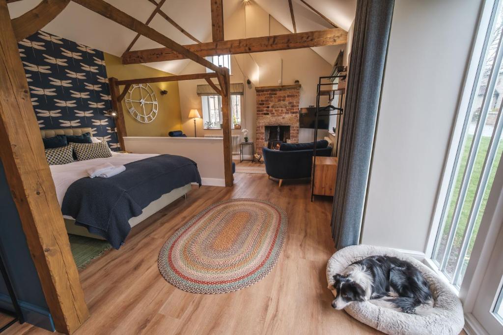 a dog laying on the floor of a bedroom at The Woodshop in Darlington