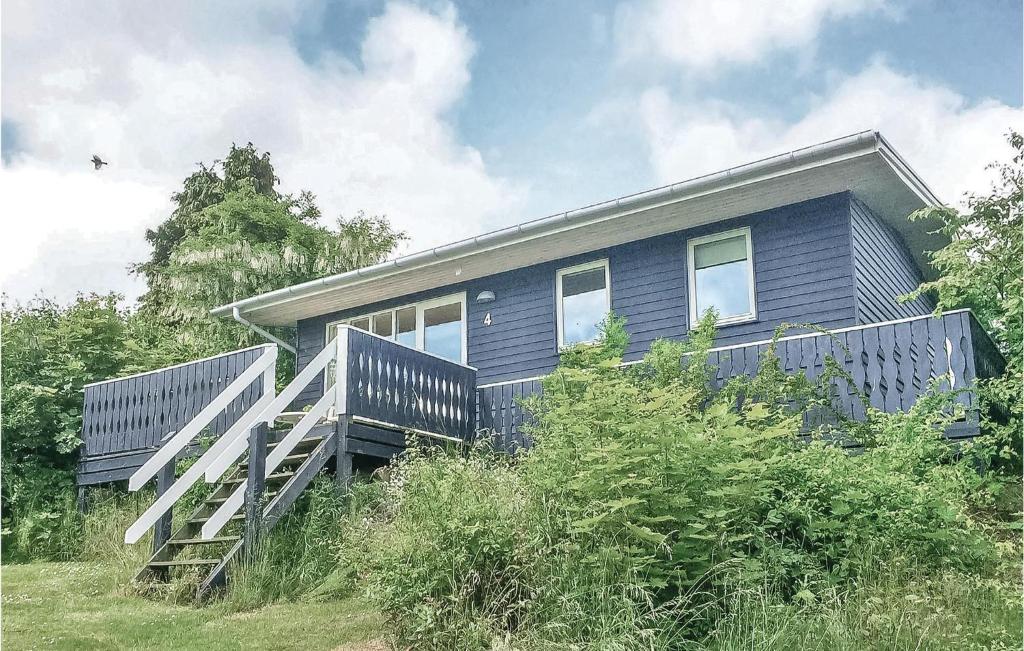 a house on a hill with a wooden deck at Mlleparken in Gudhjem