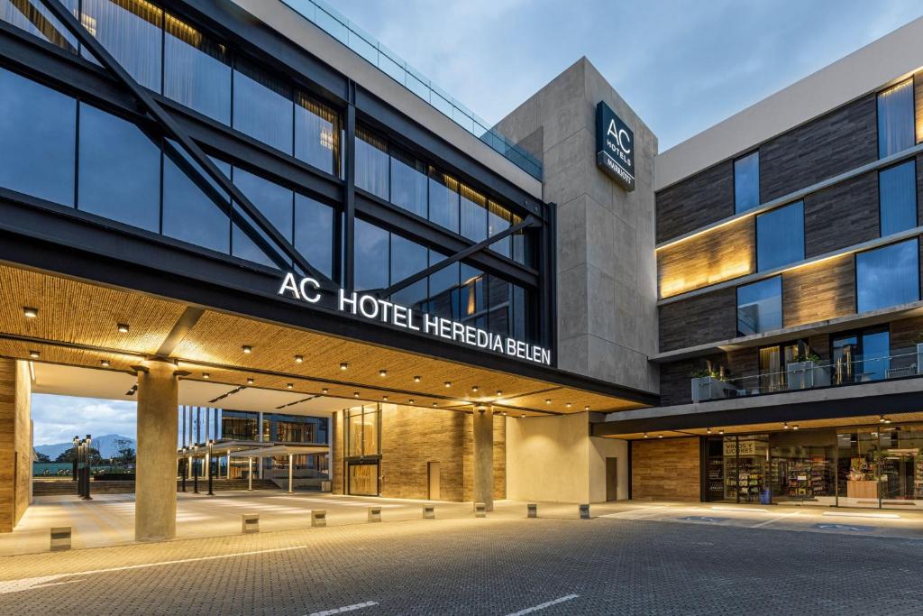 a building with an ac hotel heinemann on it at AC Hotel San Jose Airport Belen in San José