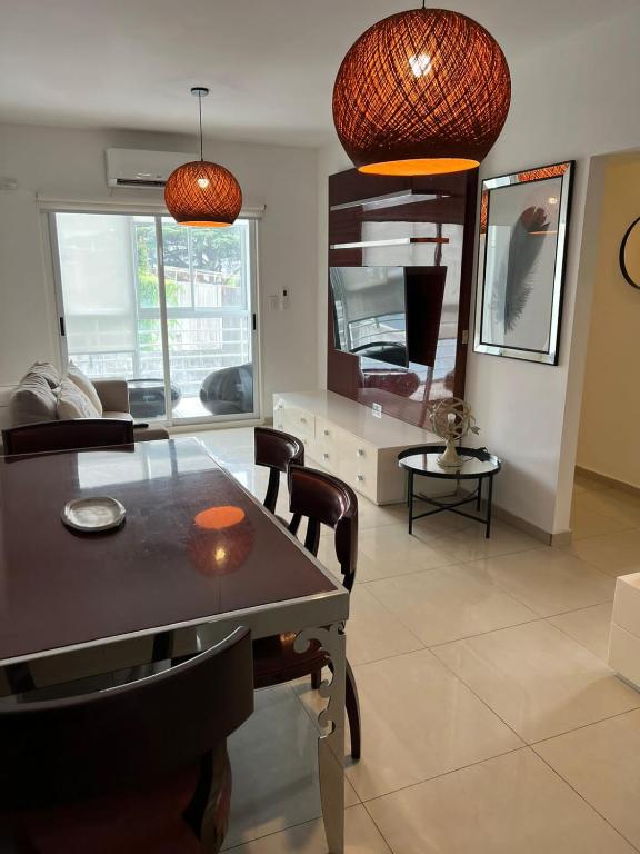 a living room with a dining room table and chairs at PALERMO APART in Buenos Aires
