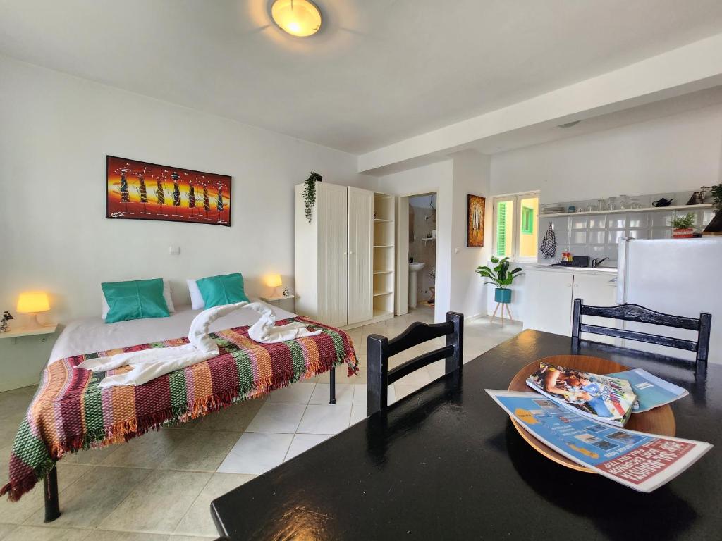 a bedroom with a bed and a table in a room at COZY STUDIO CLOSE TO THE BEACH! in Santa Maria