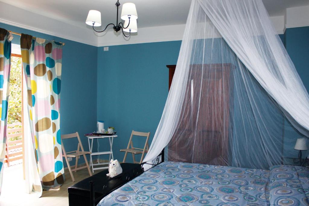 a bedroom with a bed with a mosquito net at Oasi di Francesca B&B in Pontinia