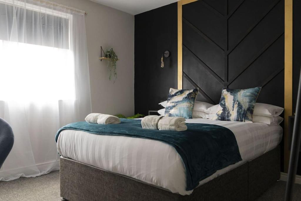a bedroom with a large bed with a large headboard at The Belfast Collection - BT7 in Belfast