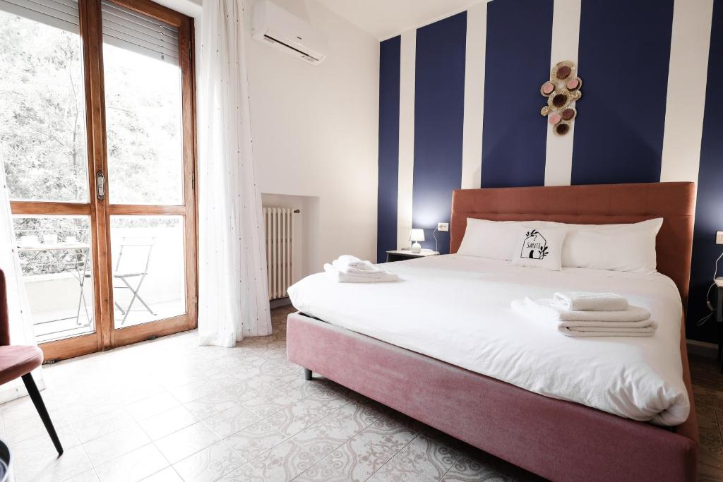 Postel nebo postele na pokoji v ubytování 2 Santi - Suite and Rooms