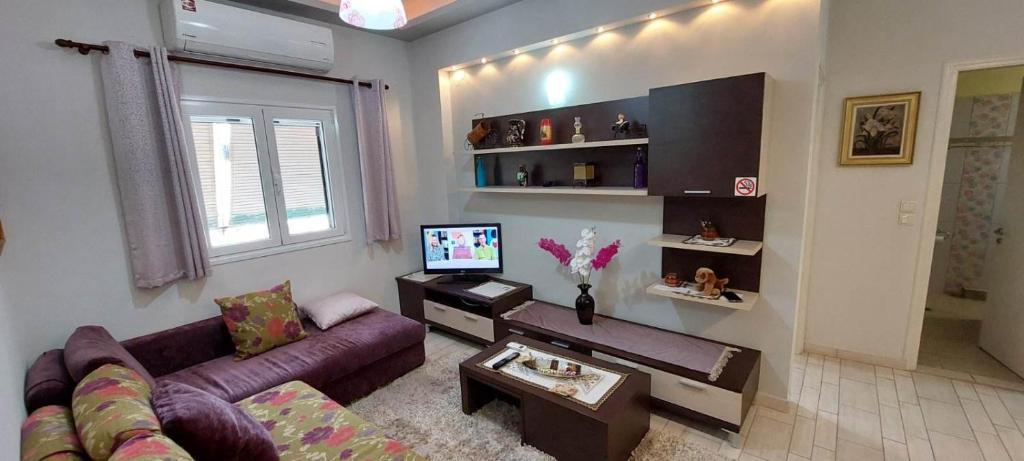 A television and/or entertainment centre at Flora's Boutique Apartment at the heart of Corfu