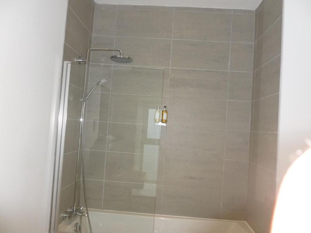 a shower with a glass door in a bathroom at Portknockie - 1 Bed Room with Ensuite in Wick