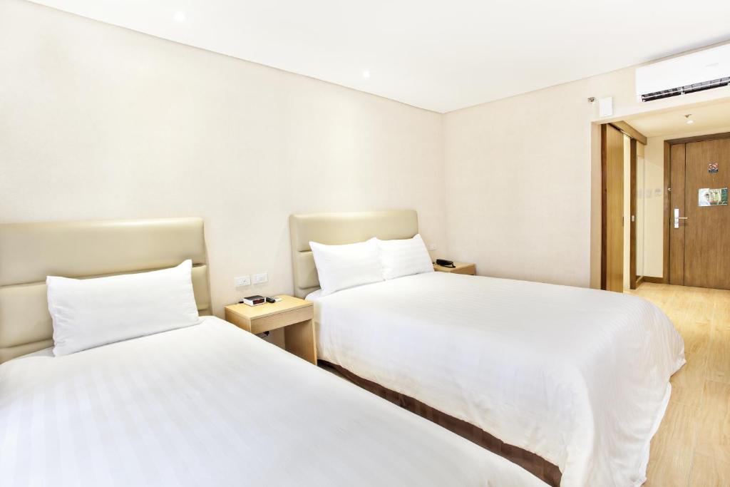 Postel nebo postele na pokoji v ubytování Jinjiang Inn - Ortigas