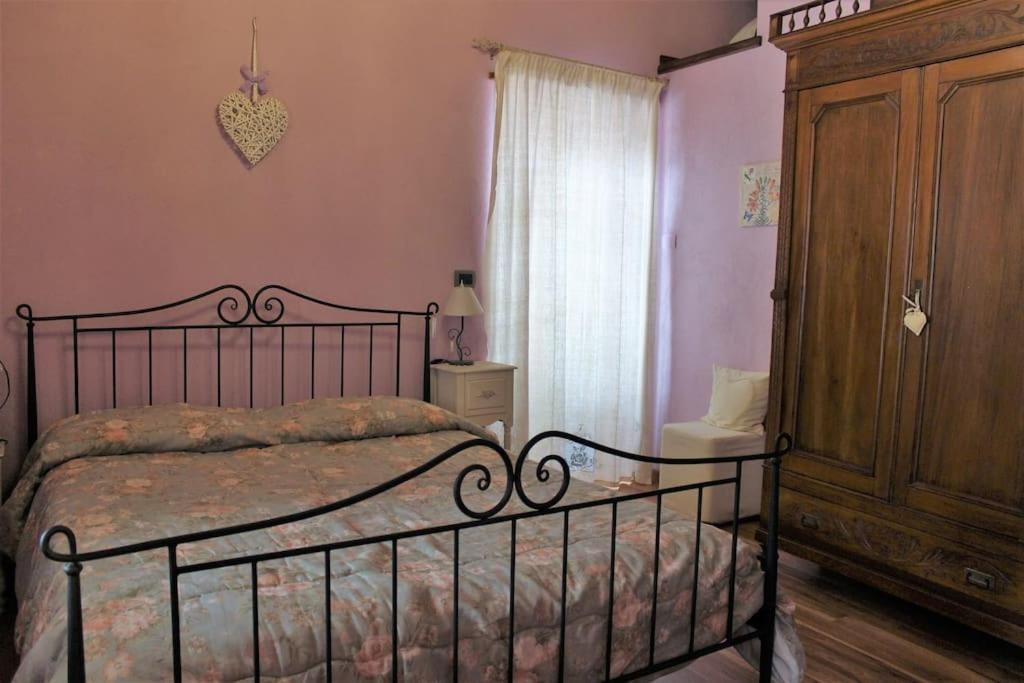 um quarto com uma cama e um armário de madeira em Casa Coccinella Valdieri - Codice CIR00423300008 em Valdieri