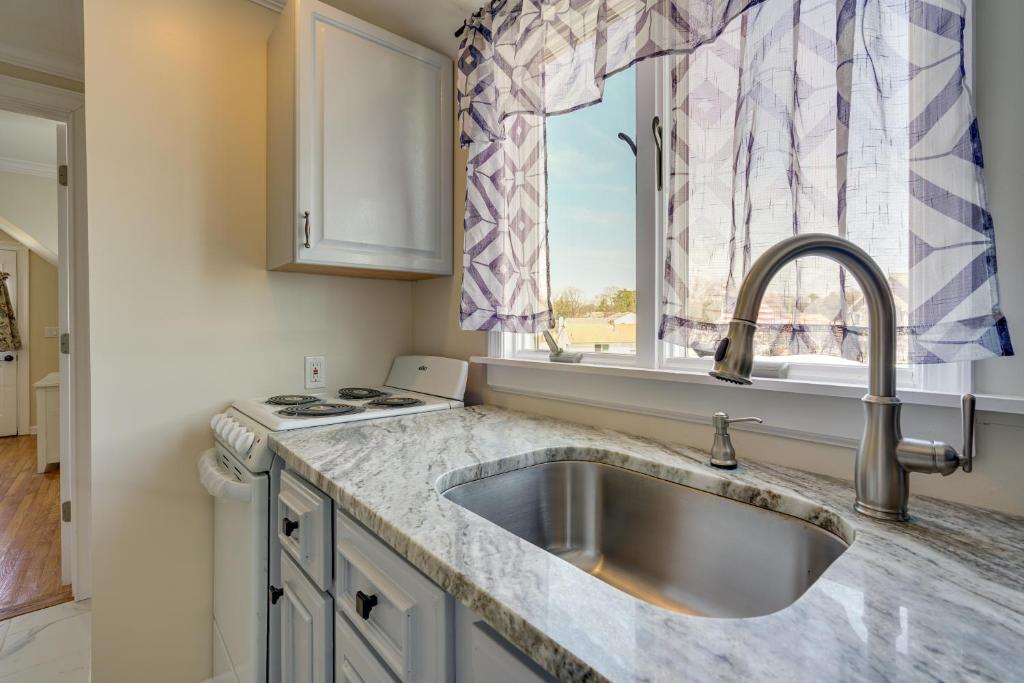 a kitchen with a sink and a window at Toms River Apartment with On-Site Canal Access! in Toms River