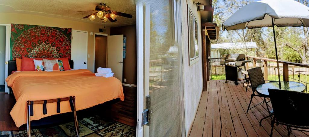 a bedroom and a balcony with a bed on a deck at Wona's 2 bedrooms full kitchen in Oakhurst