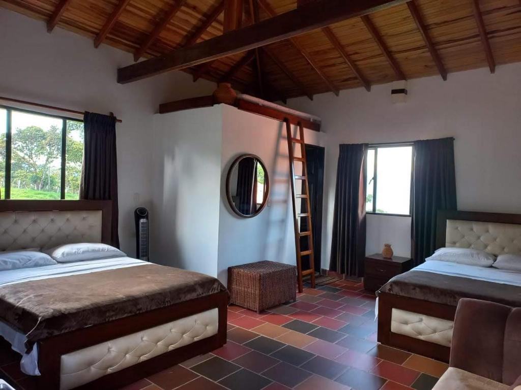 Un dormitorio con 2 camas y una escalera. en Villa Paulina, en Guadalupe