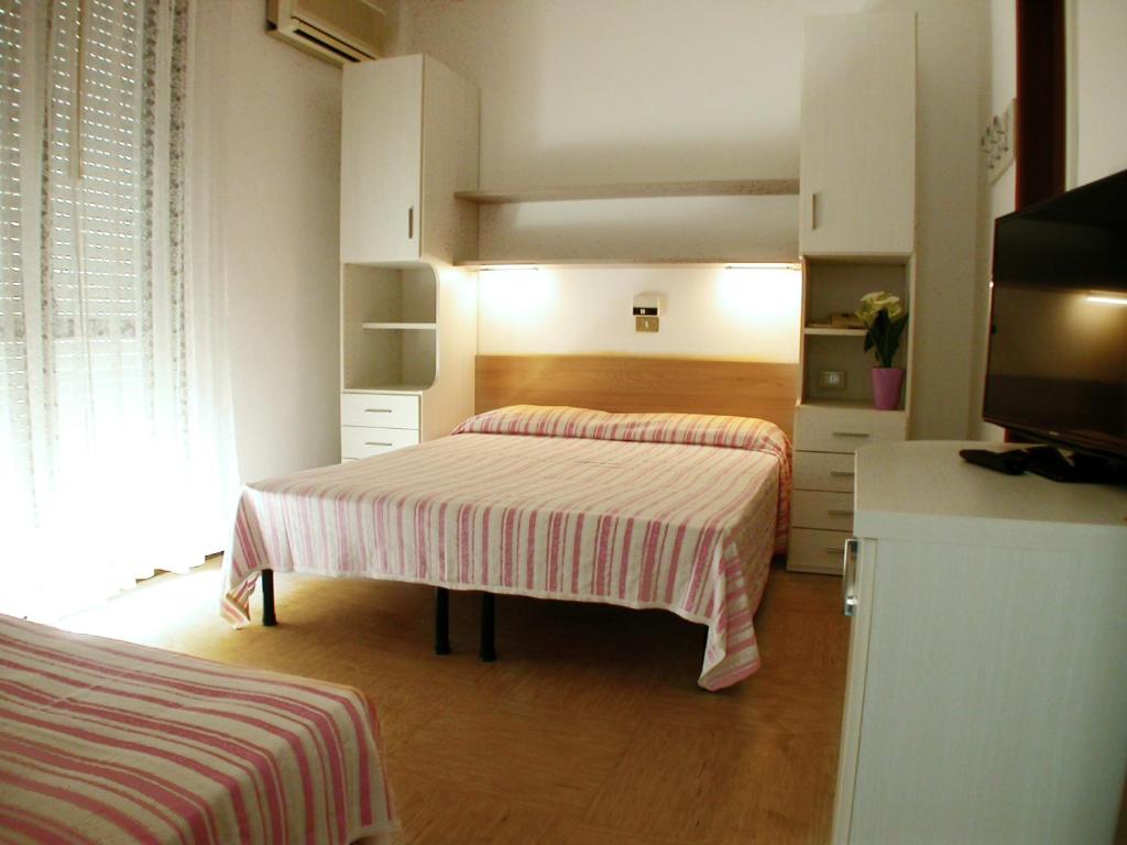 Postel nebo postele na pokoji v ubytování Albergo Aquila