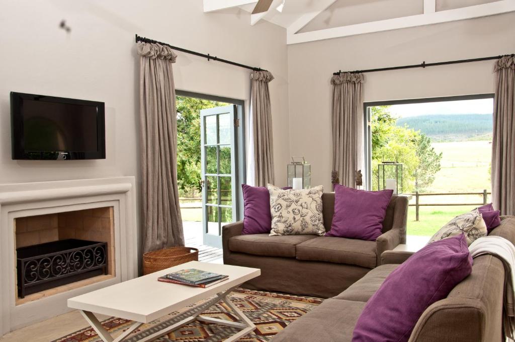 a living room with a couch and a fireplace at Country House at Kay & Monty in The Crags