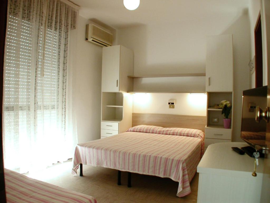 Postel nebo postele na pokoji v ubytování Albergo Aquila
