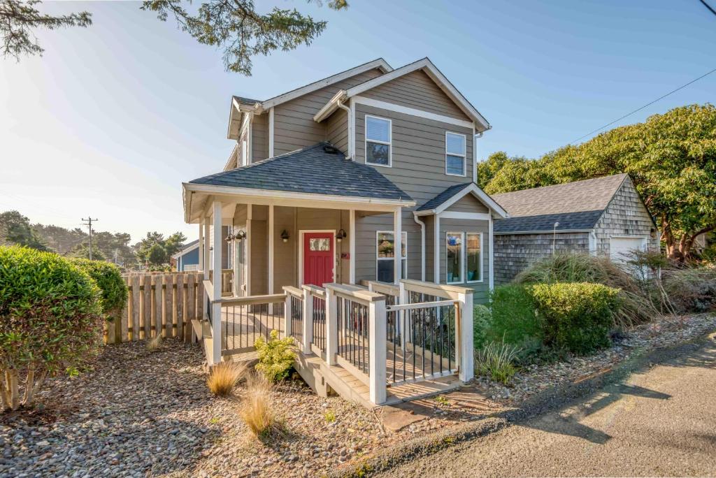 a house with a red door and a fence at Browne's Beach N'Pad in Lincoln City