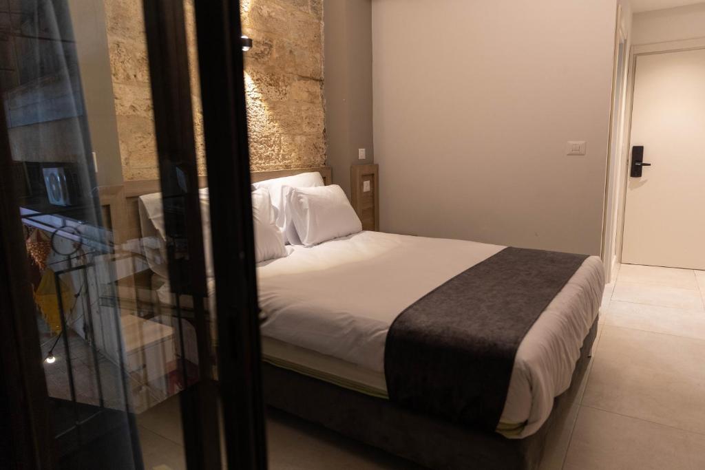 Postel nebo postele na pokoji v ubytování Saint Jacob Hotel