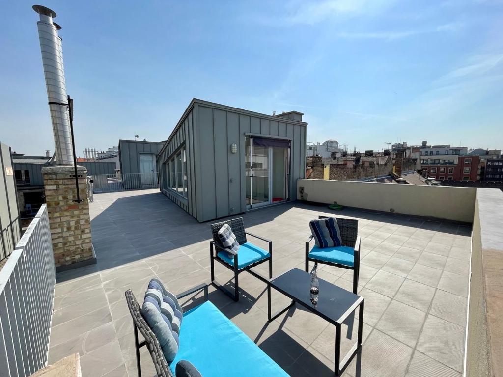 a rooftop patio with two chairs and a tiny house at Penthouse w Private Rooftop and Free parking in Budapest