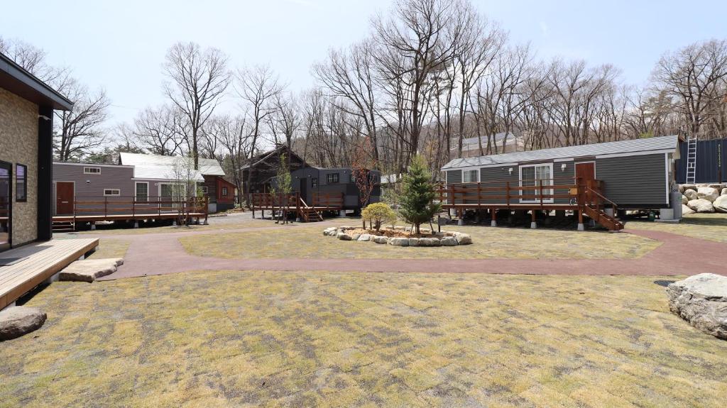a group of mobile homes in a yard at Oak Village in Hakuba