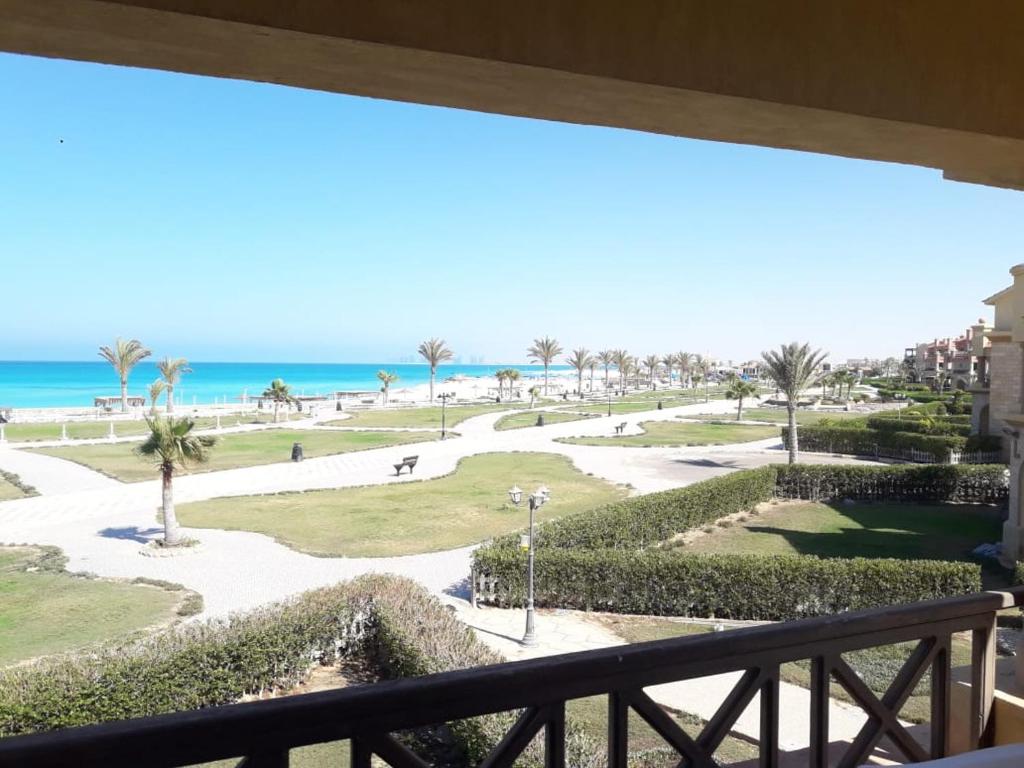 a view of the beach from the balcony of a resort at Chalet at lazourde bay in El Alamein