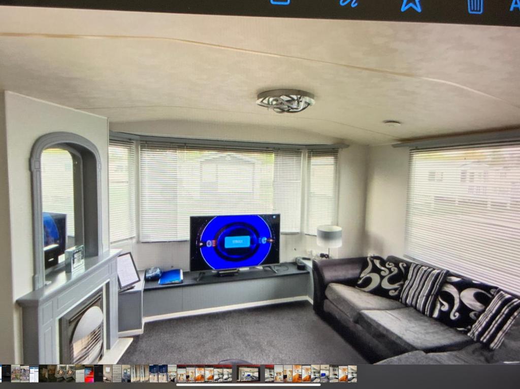 a living room with a couch and a flat screen tv at HAVEN THORPE PARK 6 Berth Caravan in Cleethorpes Waterside FREE WI FI in Cleethorpes