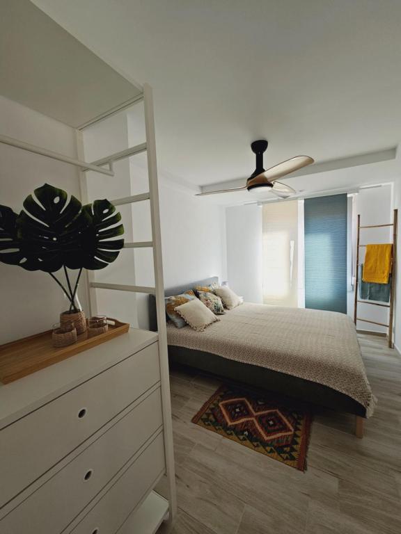 a bedroom with a bed and a dresser and a mirror at MIRADOR HOLIDAY HOME in Santa Pola