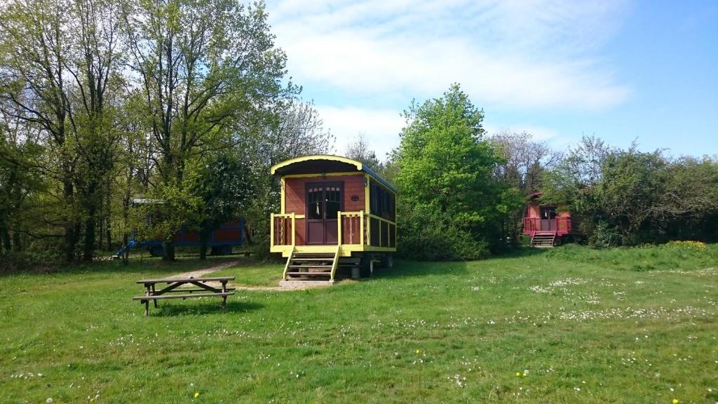 a tiny house in a field with a picnic table at Domaine de la Grangée in La Chapelle-Blanche-Saint-Martin