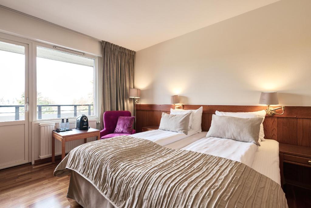 Postel nebo postele na pokoji v ubytování First Hotel Bengtsfors