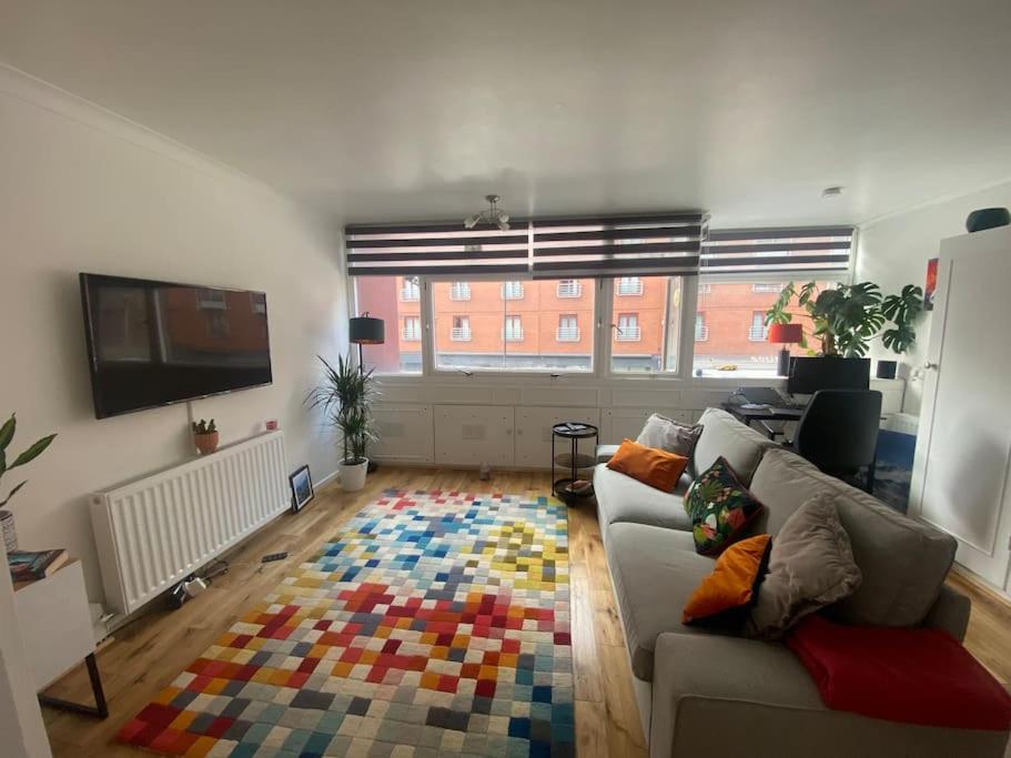 a living room with a couch and a colorful rug at 1 Bedroom apartment - City of London in London