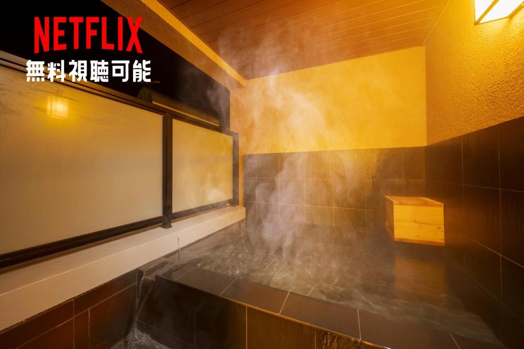 a bathroom with a window with smoke coming out of it at Tabi no yado Hanakeshiki Nadeshiko 3rd floor - Vacation STAY 42987v in Yufuin
