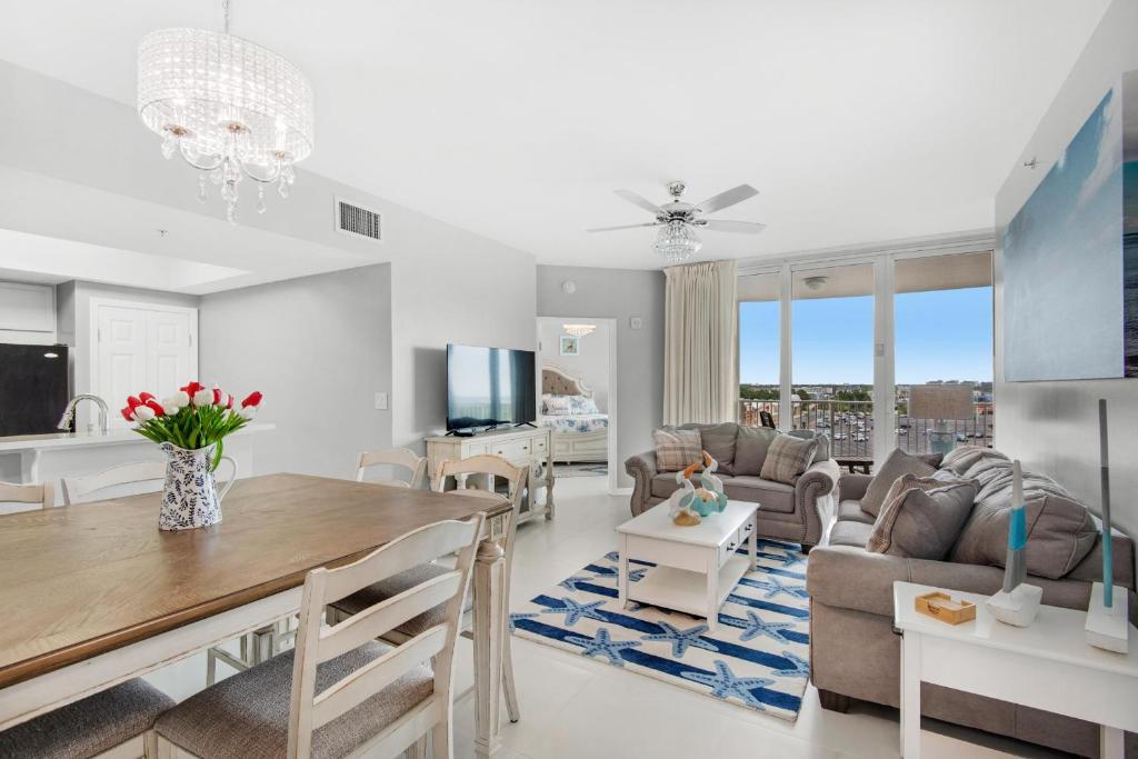a living room with a dining table and a couch at Palms Resort #1616 Full 2 Bedroom in Destin