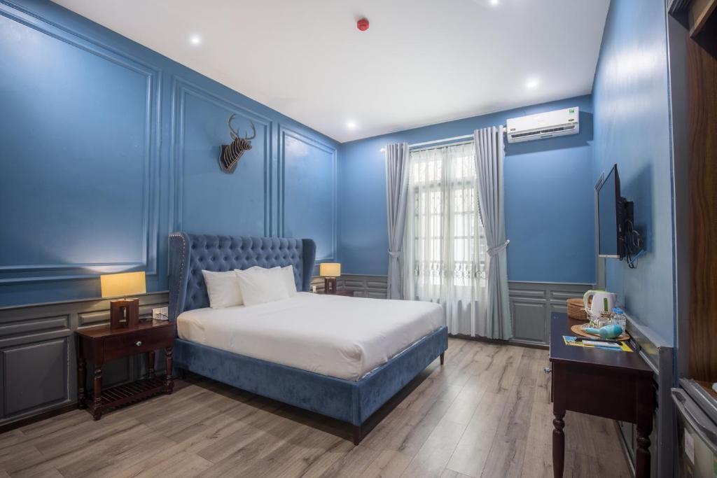 Giường trong phòng chung tại Thi Boutique Villa