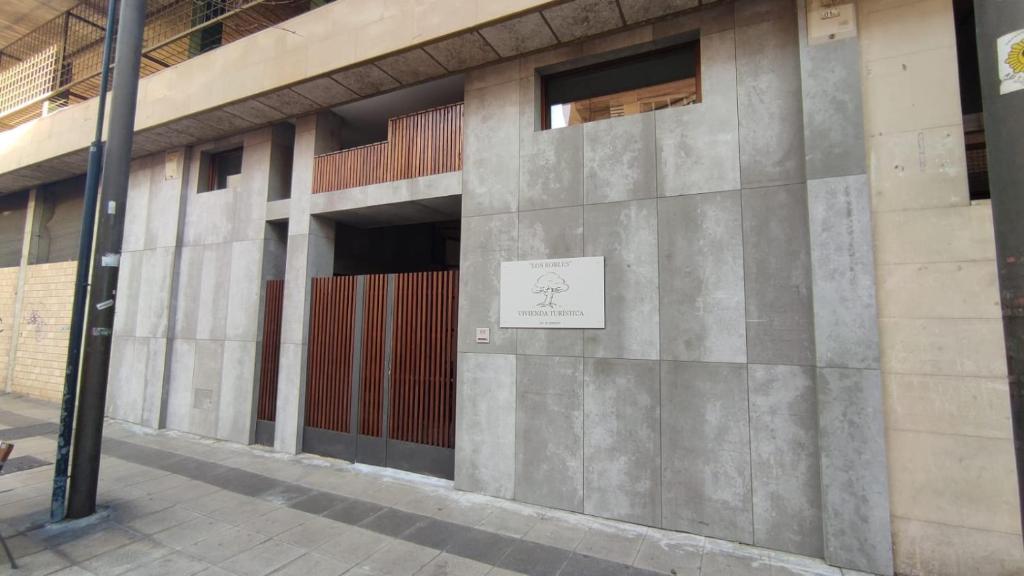 a building with a sign on the side of it at vivienda turística los Robles in Tudela