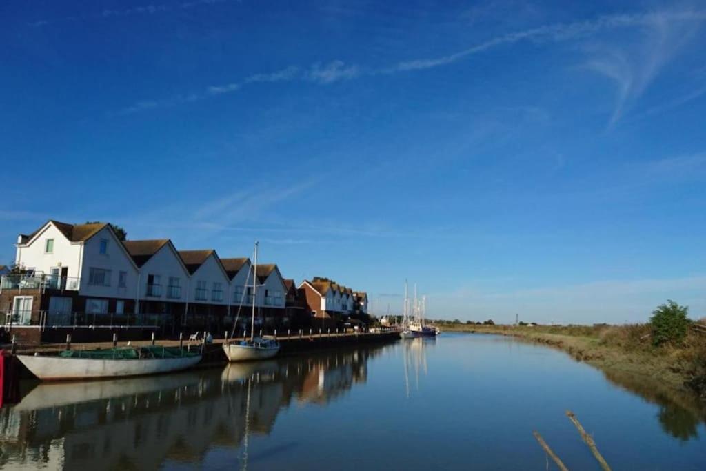 a group of boats are docked on a river at Stunning 1 bedroom apartment over looking river in Rye